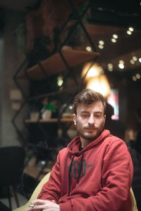 Portrait of young man sitting outdoors