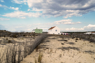 Scenic view of beach and buildings against sky