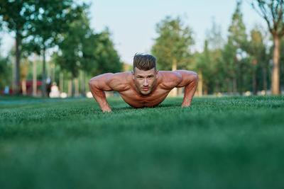 Low section of woman exercising on field