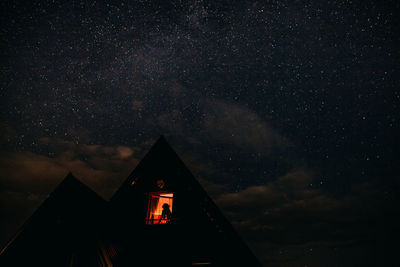 Low angle view of illuminated building against sky at night