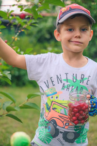 Portrait of boy holding outdoors
