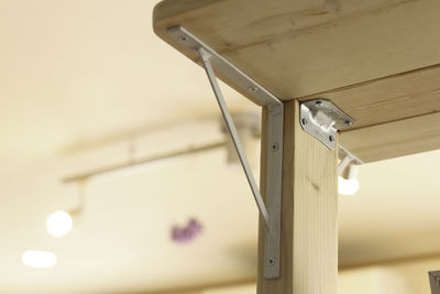 Low angle view of electric lamp hanging on ceiling at home