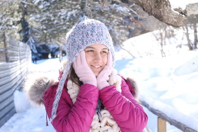 Portrait of smiling young woman in snow