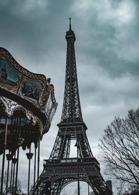 Low angle view of tower against cloudy sky