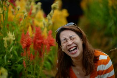 Woman laughing by plants