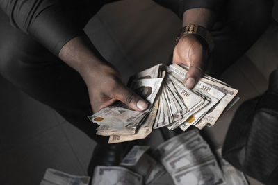 Low section of man holding paper currencies