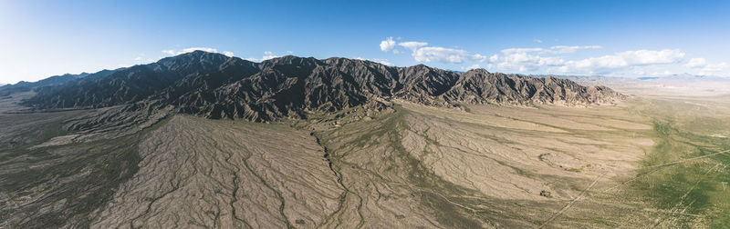 Scenic view of arid landscape against sky