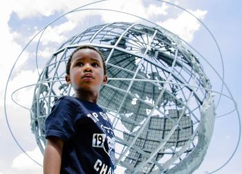 Low angle view of woman standing against sky