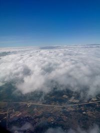 Aerial view of landscape against blue sky