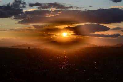 Scenic view of sunset over city