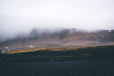 Scenic view of landscape against sky during foggy weather