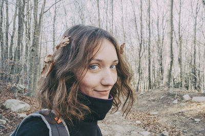 Portrait of beautiful young woman in forest