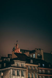 Low angle view of buildings against sky at sunset