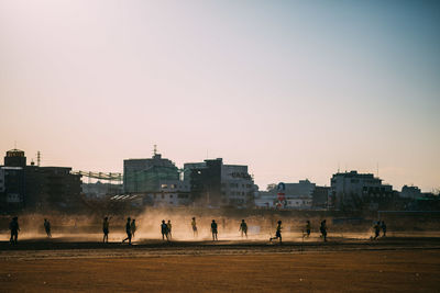 People in city at sunset