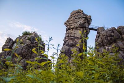 Low angle view of rock formation against sky