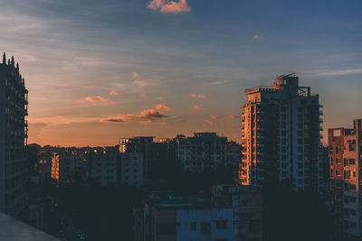 View of cityscape against cloudy sky