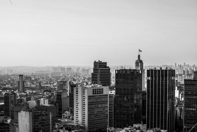 View of skyscrapers in city against clear sky