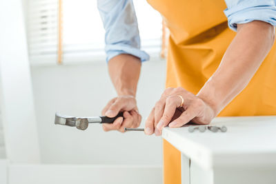 Low section of man working on cutting board