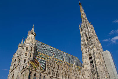 Low angle view of building against clear blue sky