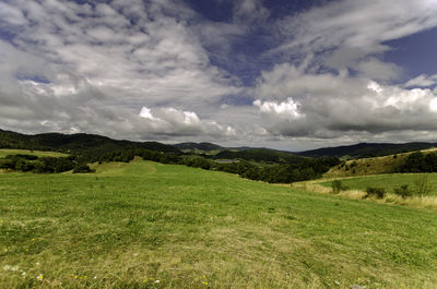 Scenic view of landscape against cloudy sky