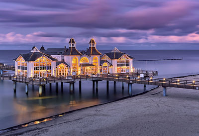 View of pier over sea against cloudy sky