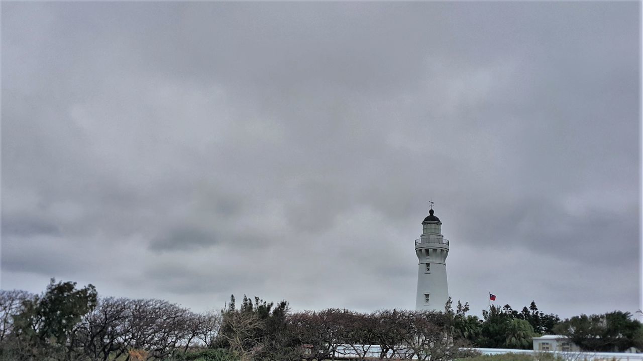 architecture, built structure, building exterior, sky, low angle view, tree, cloud - sky, lighthouse, tower, guidance, cloudy, religion, cloud, day, direction, nature, outdoors, place of worship, weather