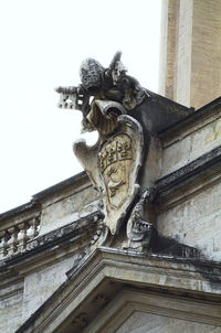 Low angle view of statue against building