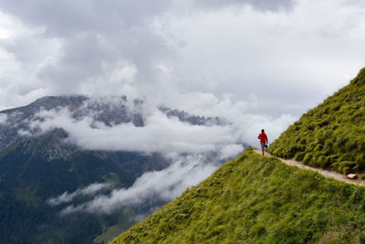 Man standing on mountain against sky