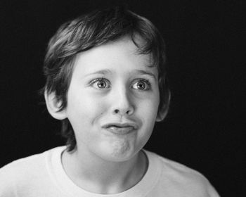 Headshot of young boy making a silly face
