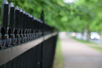 Close-up of railing by fence