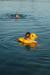 High angle view of woman swimming in lake