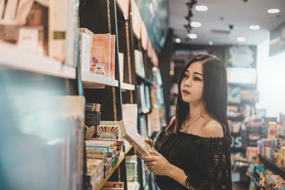 Young woman looking away at store