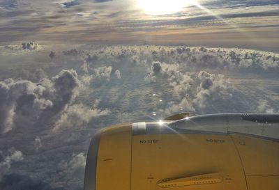 Aerial view of aircraft wing against sky