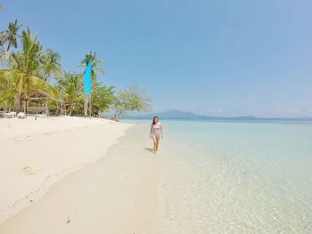 Woman on beach against sky