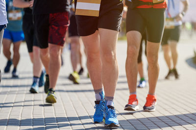 Low section of people walking on street