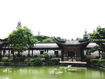 View of formal garden with trees in background