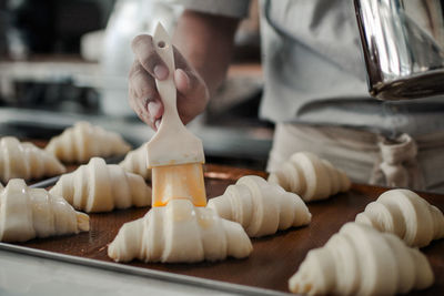 Close-up of person preparing food on table