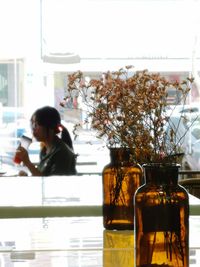Rear view of a woman sitting on table