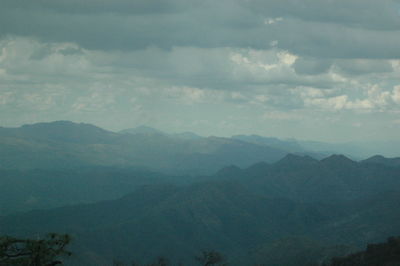 Scenic view of mountains against cloudy sky