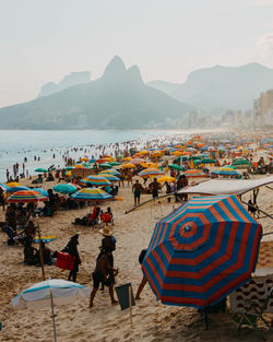 People at beach against sky