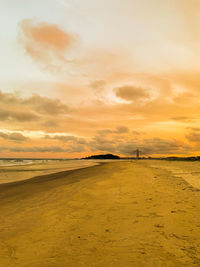 Scenic view of beach against sky during sunset