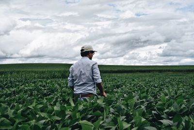 Man working on field against sky