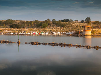 Scenic view of lake against cloudy sky