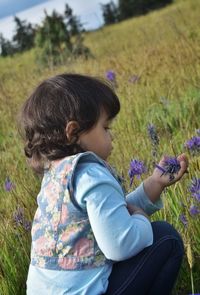 Side view of woman on purple flower field