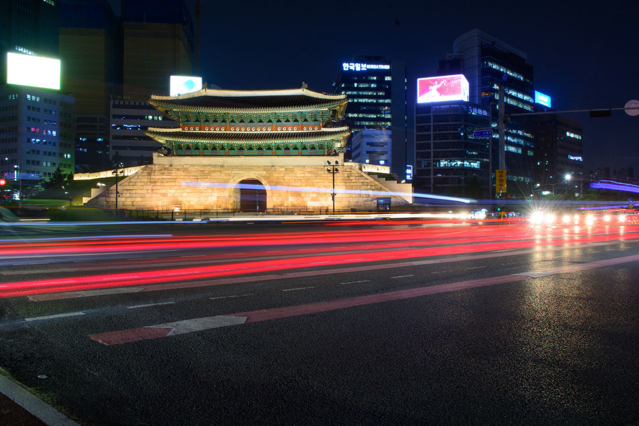 LIGHT TRAILS ON ROAD AT NIGHT