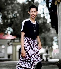 Portrait of teenage girl standing outdoors