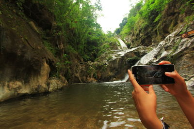 Man photographing on mobile phone