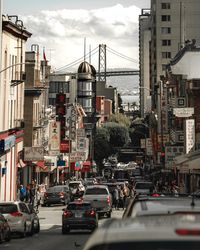 Traffic on city street and buildings against sky