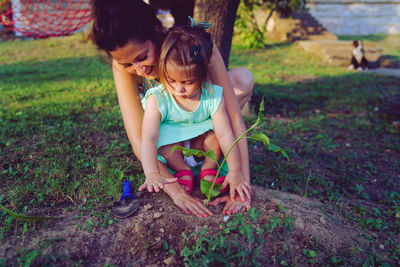 Mother and daughter planting plant