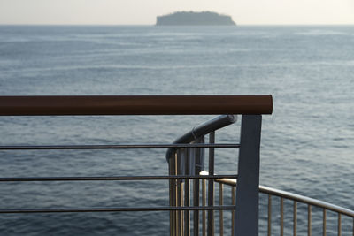 Close-up of railing against sea